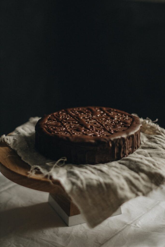 pexels-photo-2067436 Delicious chocolate cake placed on rustic linen, ideal for dessert photography.